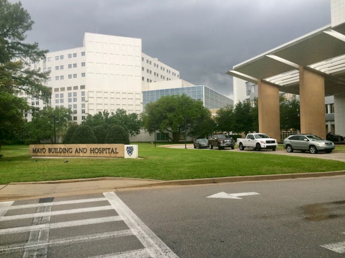 This image shows a hospital building with a sign reading 